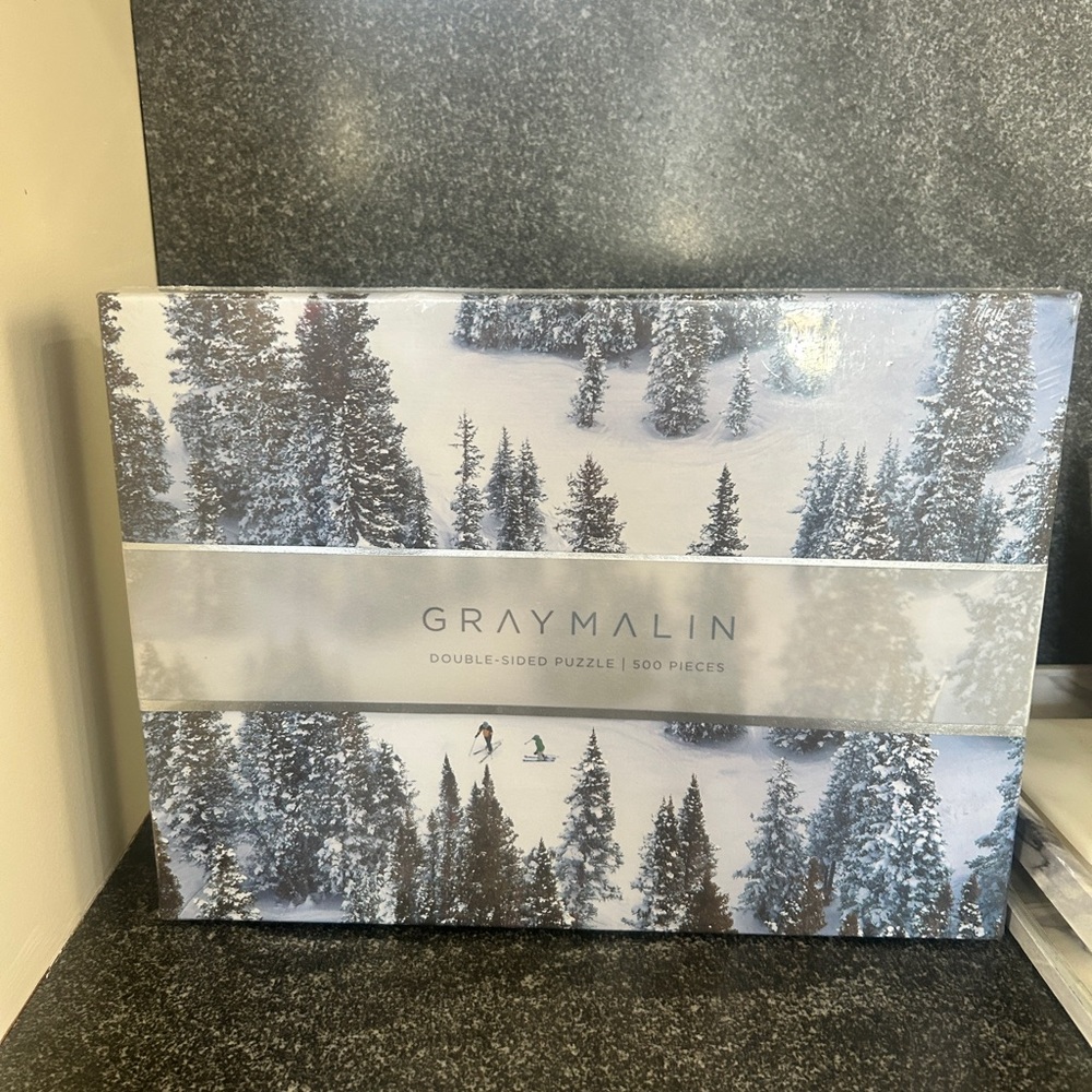 NIB, unopened box . Gray Malin Puzzle — Snowy White and Green Pine Forest